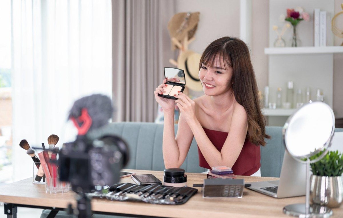 A seller holding products up to camera in a live setup